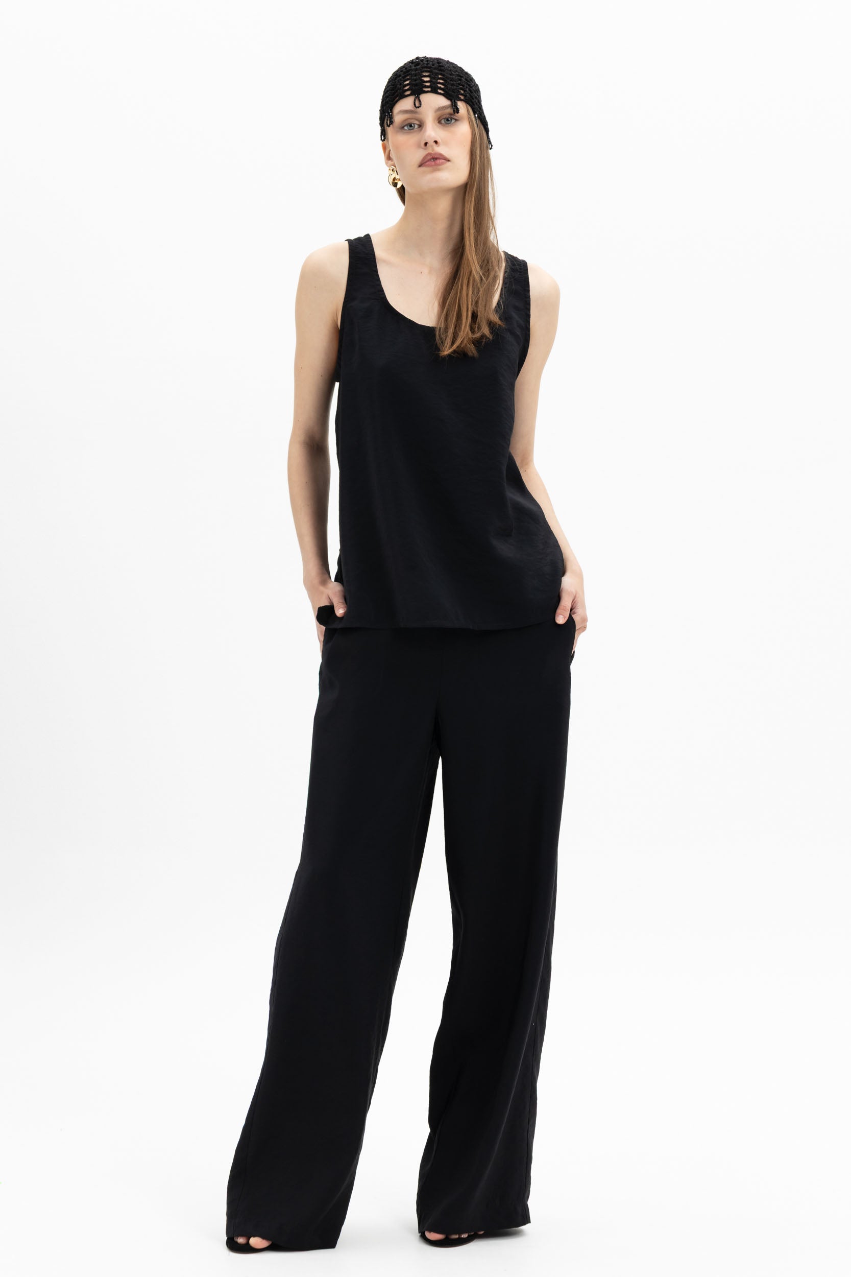 Black Fluid Wide-Leg Pants by MYT paired with a sleeveless tank top, showcasing a relaxed, flowing fit for women.
