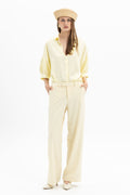 Yellow wide-leg pants from MYT worn with a matching blouse, showcasing a stylish, flowy women's outfit.