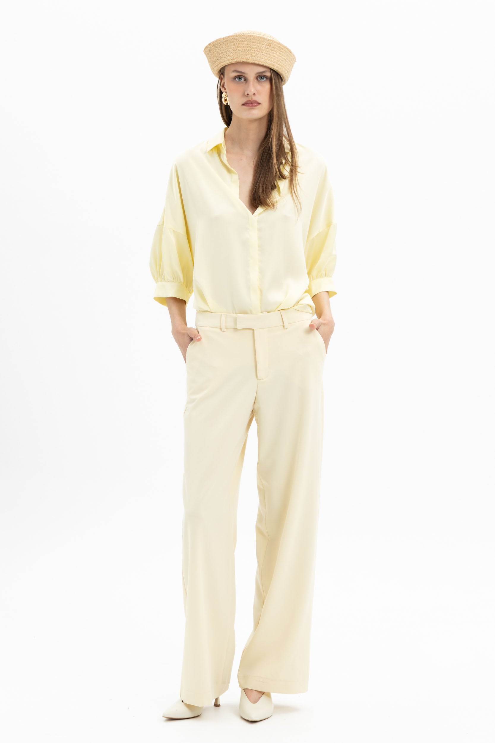 Yellow wide-leg pants from MYT worn with a matching blouse, showcasing a stylish, flowy women's outfit.
