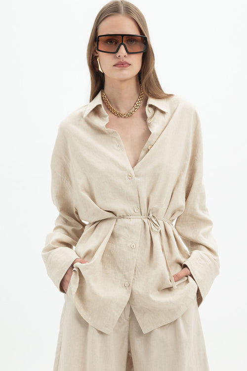 Sand beige linen long sleeve belted shirt from MYT, styled with matching shorts, casual and comfortable for women.