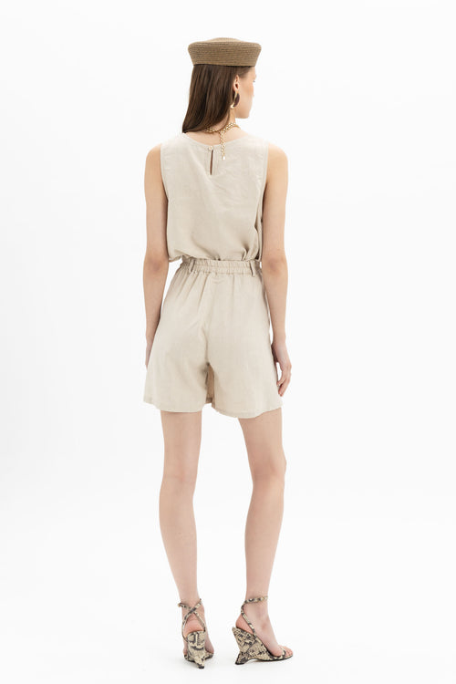 Beige linen Bermuda shorts from MYT worn with a sleeveless tank top, showcasing casual summer style and comfortable fit.